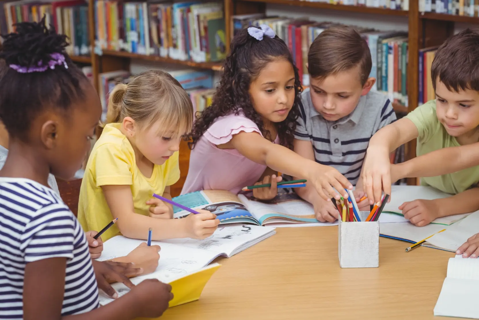 kids reaching for pencils